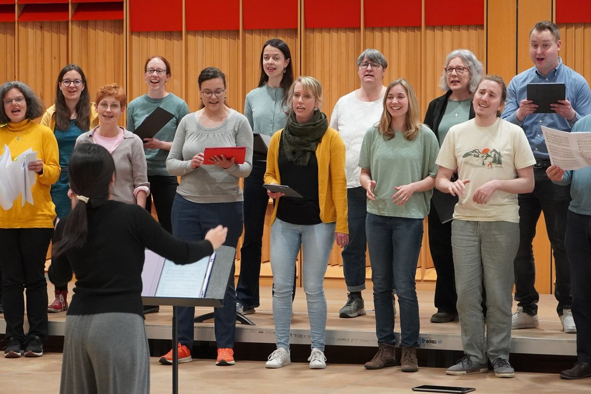 singender Chor mit Chorleiterin